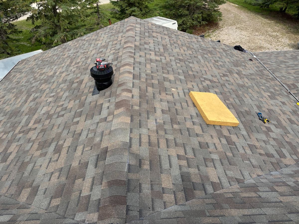 Brown hip roof drone view with ventilation
