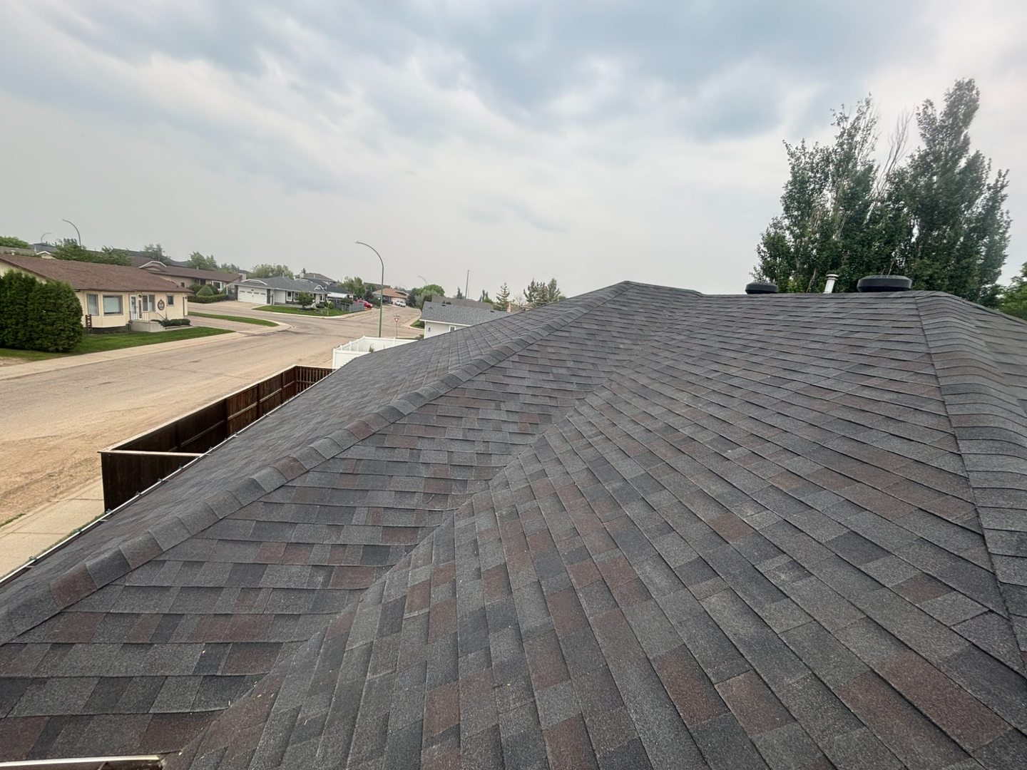 Completed roof with clean eavestroughs in Yorkton neighbourhood