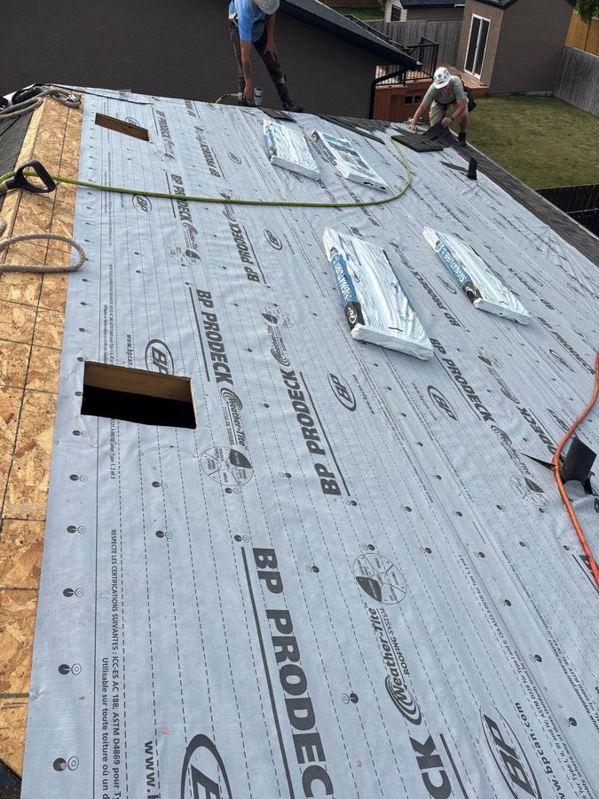 Crew members installing shingles over BP ProDeck underlayment
