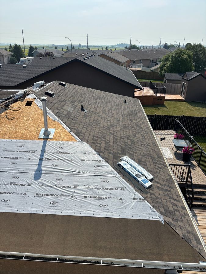 Half-completed roof replacement showing BP ProDeck and new shingles in Yorkton