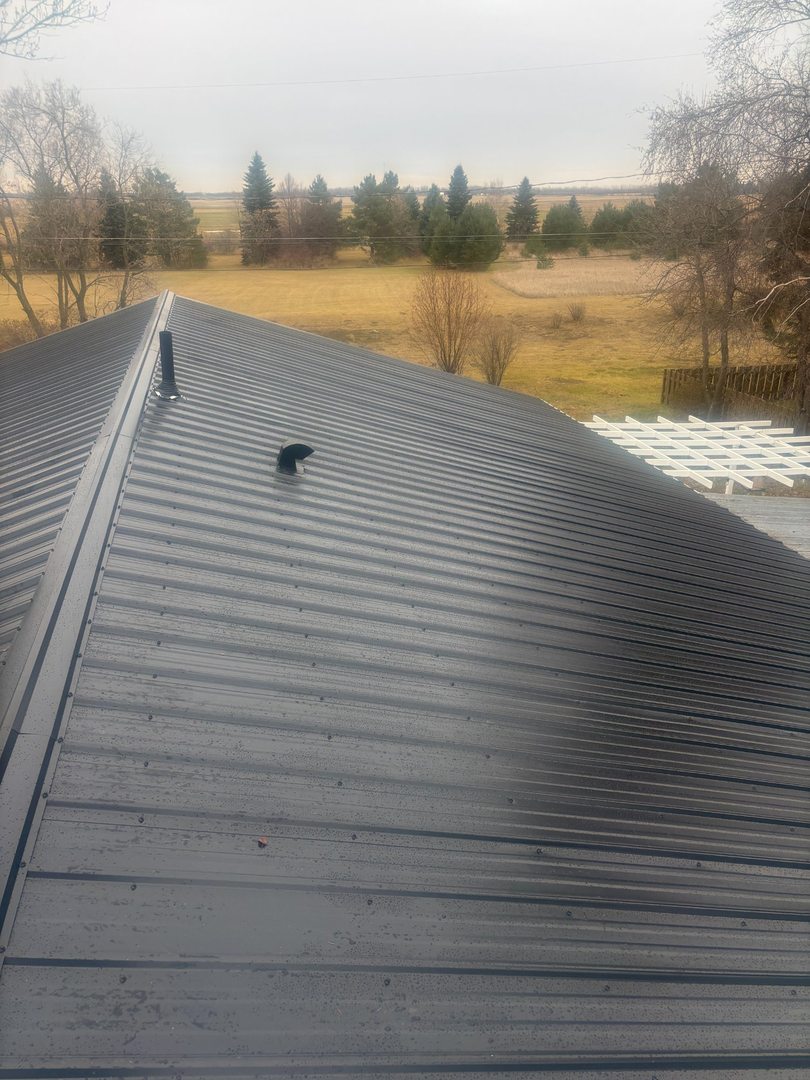 Metal roof installation with prairie backdrop near Insinger Saskatchewan